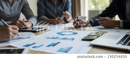 Office Team Collaboration on Financial Reports and Data Analysis in Modern Workspace 130254850