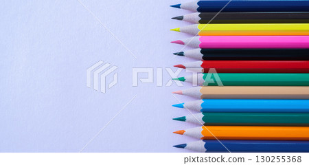A lot of color pencils on the bright lila paper background. Close up. Design concept. Space for text. A lot of color pencils on the bright lila paper background. Close up. Design concept. Space for text. 130255368