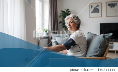 Senior Woman Relaxing at Home While Monitoring Blood Pressure with Medical Equipment 130255435