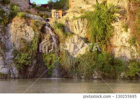 Dirty sewage flow in mountain river 130255695