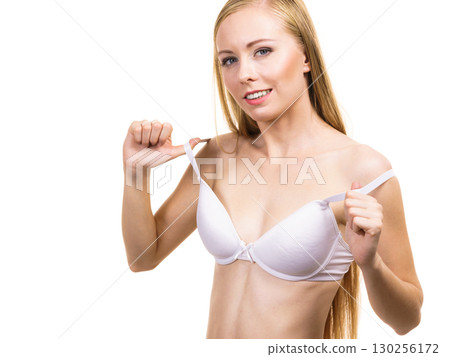 Young woman holding bra strap Young woman holding bra strap 130256172