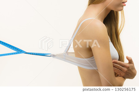 Woman wearing too big bra, loose band Woman wearing too big bra, loose band 130256175