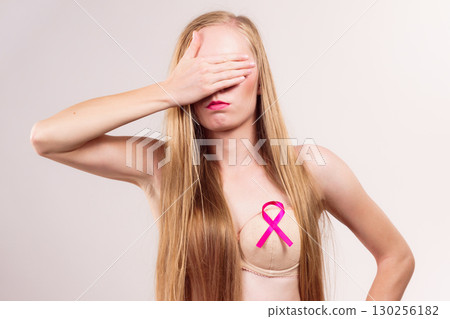 Woman pink cancer ribbon on breast Woman pink cancer ribbon on breast 130256182