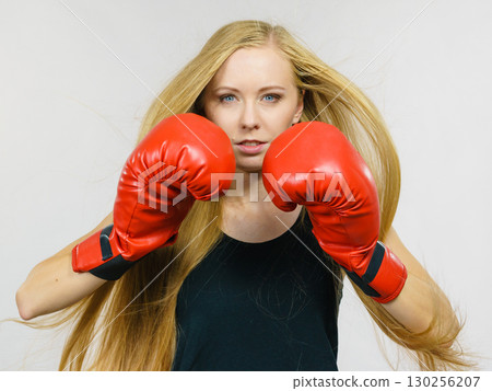 Woman in gloves playing sports boxing 130256207