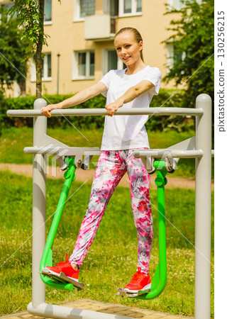 Woman doing exercise in outdoor gym 130256215