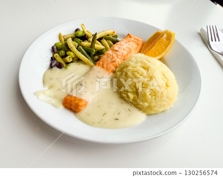 Plate with salmon, mashed potatoes and vegetables. Healthy eating, balanced nutrition and traditional lunch option. Plate with salmon, mashed potatoes and vegetables. Healthy eating, balanced nutrition and traditional lunch option. 130256574