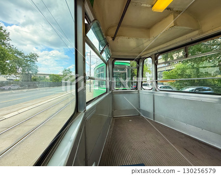 Interior of old retro tram with empty seats. Urban transport, public commuting, and nostalgic travel in European city heritage. Interior of old retro tram with empty seats. Urban transport, public commuting, and nostalgic travel in European city heritage. 130256579