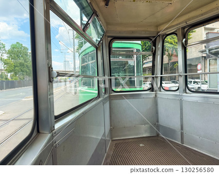 Interior of old retro tram with empty seats. Urban transport, public commuting, and nostalgic travel in European city heritage. Interior of old retro tram with empty seats. Urban transport, public commuting, and nostalgic travel in European city heritage. 130256580