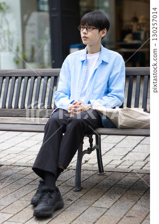 坐在城市長椅上的年輕人 130257014