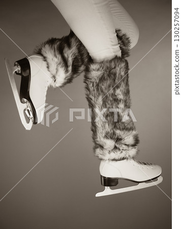 Woman legs wearing ice skates fur socks, skating Woman legs wearing ice skates fur socks, skating 130257094