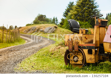 Combine harvester standing next to coutryside path Combine harvester standing next to coutryside path 130257104