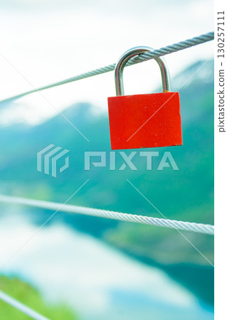 Red padlock and Geirangerfjord from Flydasjuvet viewpoint Norway Red padlock and Geirangerfjord from Flydasjuvet viewpoint Norway 130257111