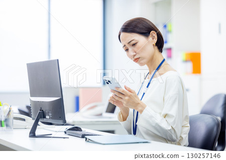 A woman operating a smartphone A woman operating a smartphone 130257146