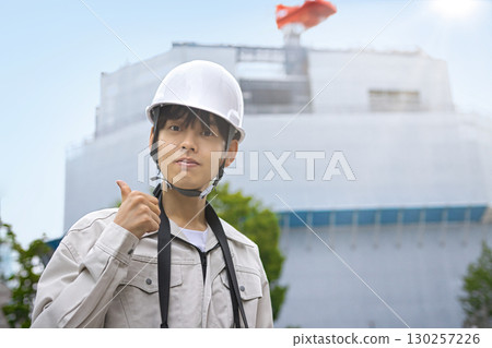 Young businessman in work clothes looking at a tablet at a construction site 130257226