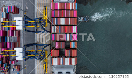 Aerial view container cargo ship at port with tugboat, Business global import export logistic maritime transport by container cargo ship vessel, International trade container cargo freight shipping. 130257565