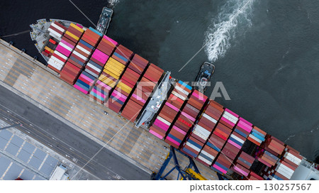 Aerial view container cargo ship at port with tugboat, Business global import export logistic maritime transport by container cargo ship vessel, International trade container cargo freight shipping. 130257567