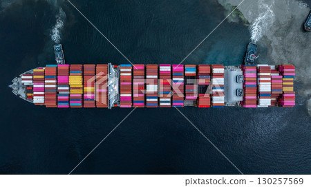 Aerial view container cargo ship at port with tugboat, Business global import export logistic maritime transport by container cargo ship vessel, International trade container cargo freight shipping. 130257569