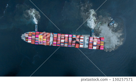 Aerial view container cargo ship at port with tugboat, Business global import export logistic maritime transport by container cargo ship vessel, International trade container cargo freight shipping. 130257571