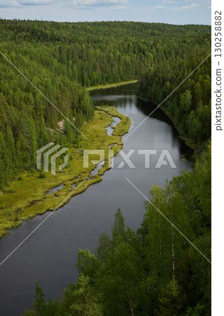A Beautiful Scenic River Flowing Gracefully Through the Lush Green Forest Landscape A Beautiful Scenic River Flowing Gracefully Through the Lush Green Forest Landscape 130258882