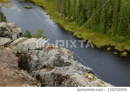 A Beautiful Serene River Landscape Featuring a Rocky Outcrop Surrounded by Lush Greenery A Beautiful Serene River Landscape Featuring a Rocky Outcrop Surrounded by Lush Greenery 130258909