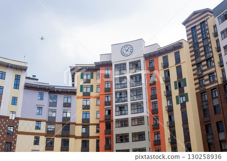 modern apartment building with a clock on the facade 130258936
