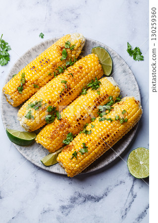 Grilled corn with cilantro, spices and butter. Grilled corn with cilantro, spices and butter. 130259360