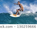 Male surfer on a blue wave 130259666