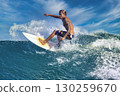 Male surfer on a blue wave 130259670
