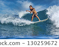 Male surfer on a blue wave 130259672