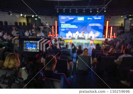 Professional conference recording with camera view and stage in background 130259696