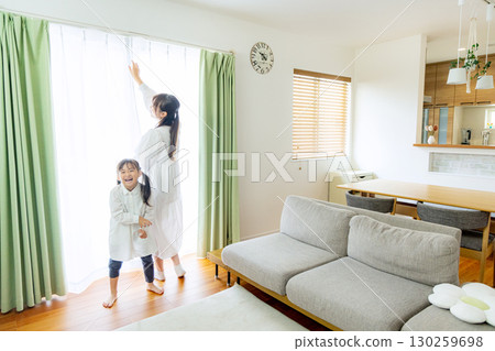 Parent and child relaxing in the living room 130259698