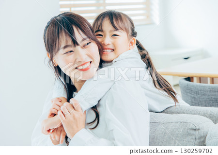 Elementary school girl who is sweetened with her mother 130259702