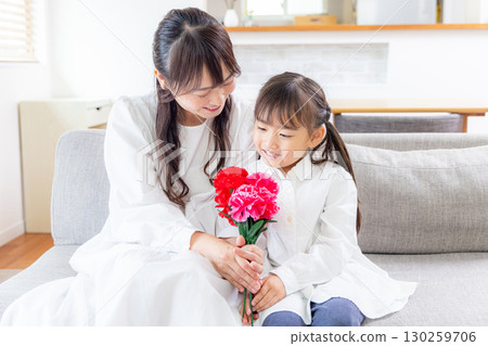 Girl handing a bouquet of carnations 130259706