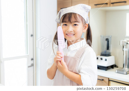 Girl with a kitchen knife 130259708