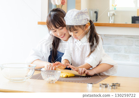 Parent and child making cookies 130259722