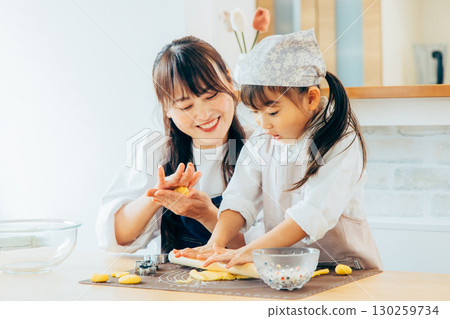 Parent and child making cookies 130259734