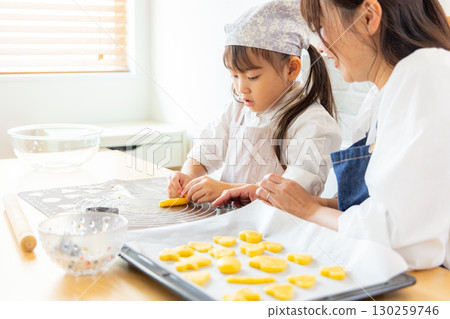 Parent and child making cookies 130259746