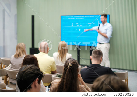 Speaker giving presentation to attentive audience in a seminar setting Speaker giving presentation to attentive audience in a seminar setting 130259826