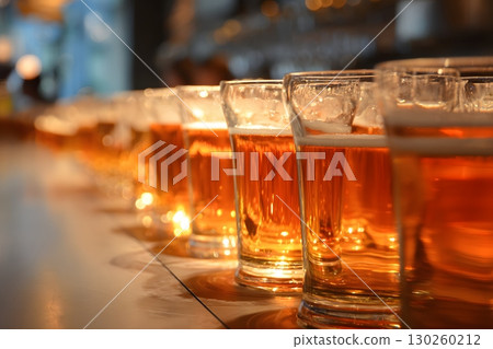 Beer glasses lined up on a counter, 130260212
