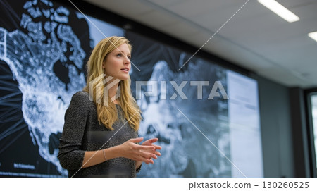 female leader in boardroom with logistics network on big screen female leader in boardroom with logistics network on big screen 130260525