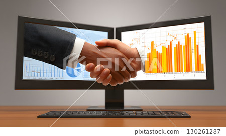 agreement finalized with handshake and charts on monitor 130261287