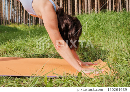 Mature woman practice yoga on fitness mat at public park. Healthy lifestyle Mature woman practice yoga on fitness mat at public park. Healthy lifestyle 130261689