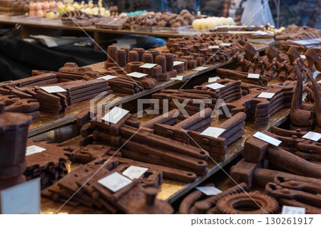 Chocolate tools and nuts displayed on wooden shelves at market stall Chocolate tools and nuts displayed on wooden shelves at market stall 130261917