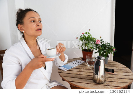 Relaxing Morning Coffee Enjoyed on a Cozy Patio With Natural Decor 130262124