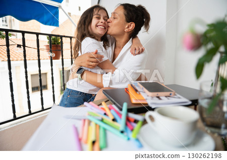 Mother and Daughter Sharing Loving Moments on a Balcony Workspace 130262198