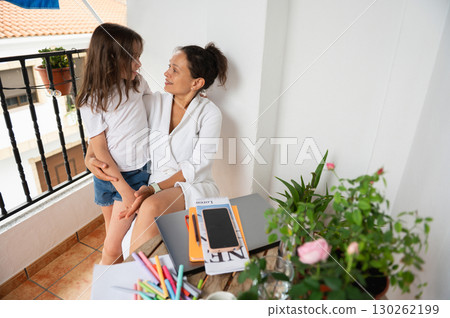 Mother and Daughter Spending Quality Time Together on a Cozy Balcony 130262199