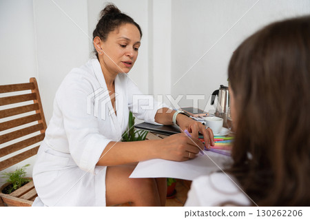 Woman Engaged in Discussion at Home with Warm and Casual Attire Woman Engaged in Discussion at Home with Warm and Casual Attire 130262206
