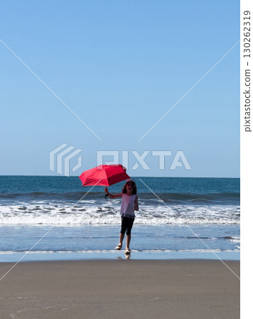 Kid run with red umbrella on beach Kid run with red umbrella on beach 130262319