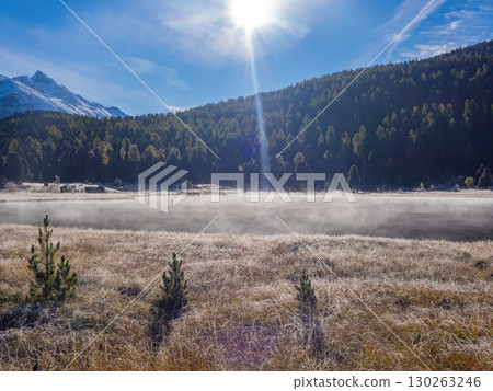 St. Moritz, Switzerland - October 6th 2024: Idyllic lake Lej da Staz in the morning sunlight St. Moritz, Switzerland - October 6th 2024: Idyllic lake Lej da Staz in the morning sunlight 130263246