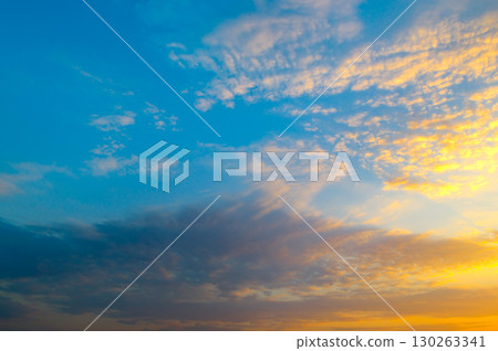 Sky with vibrant clouds at sunset, gradient from blue to orange. Sky with vibrant clouds at sunset, gradient from blue to orange. 130263341